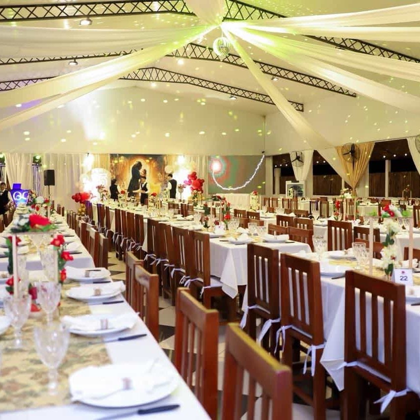 Salón de eventos decorado con mesas y sillas