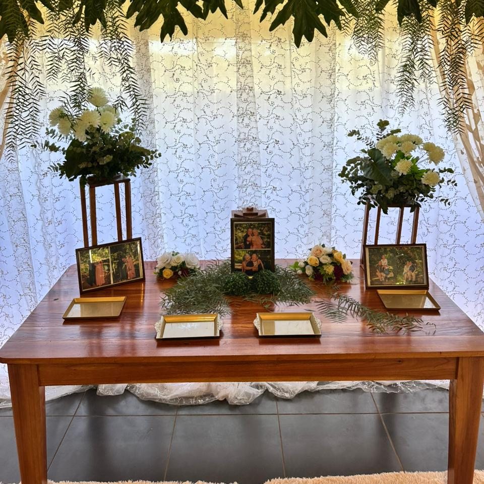 Mesa decorada con flores y marcos de fotos